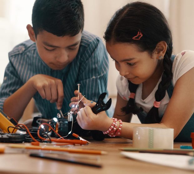 future-is-good-hands-shot-two-adorable-young-siblings-building-robotic-toy-car-together-home